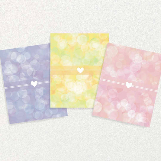 Front of New Baby Keepsake Prompt Cards set of three each has a white heart in front of different background - purple, yellow, or pink